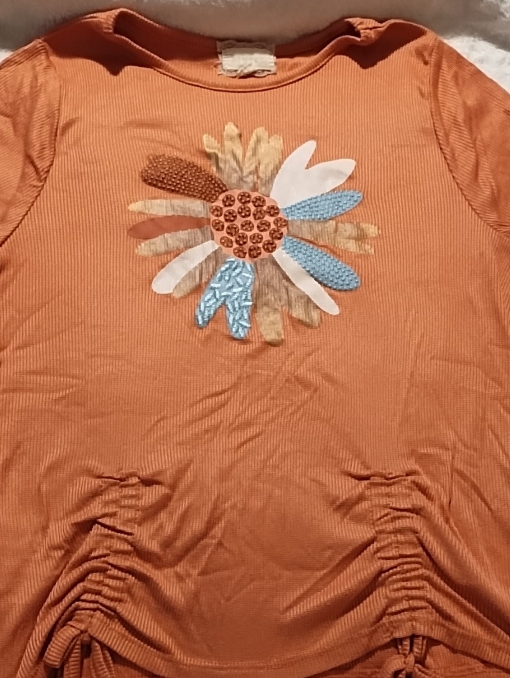 Between Orange Top With Multi Colored Flower